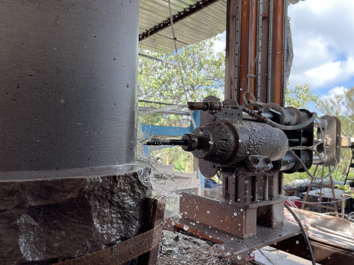 Router CNC desbastando una columna de cantera con refrigeración de agua